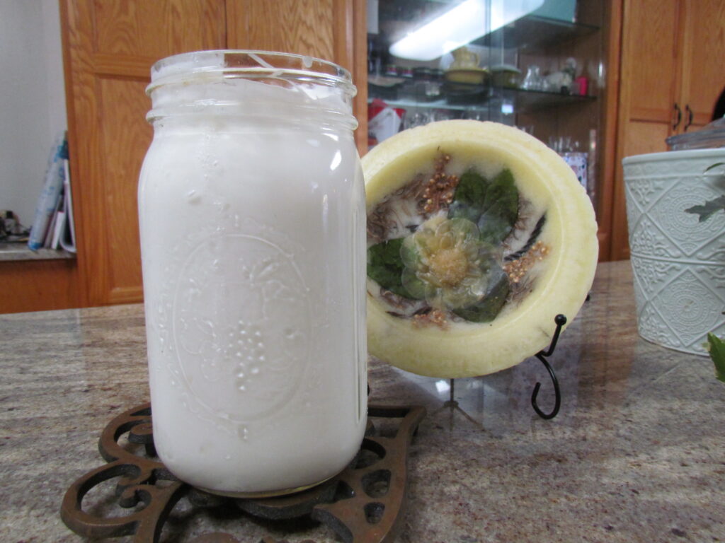 Picture of finished yogurt in a quart jar.